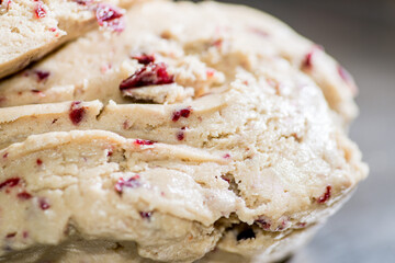 Raw light dough with cranberries. Red berries in raw dough. Bakery concept