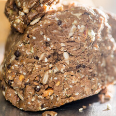 Raw brown dough with nuts and seeds. Preparing the dough for baking