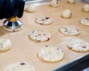 Baker shapes cookies from raw dough
