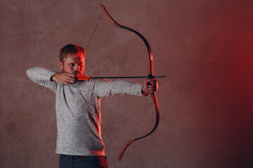 Archer bearded man with classic bow and arrow