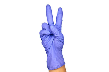 A female hand in a medical glove shows the gesture of victory.