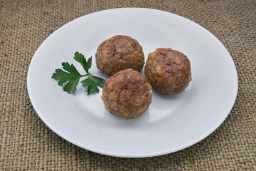 Cutlets on a white plate on the table