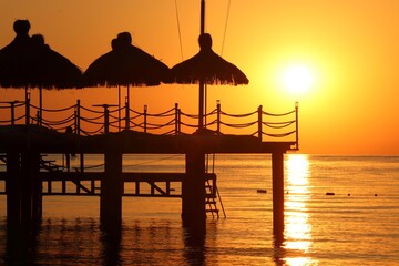 
The silhouette of the pier against the background of the sunset and the Mediterranean sea.