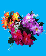 Beautiful artificial flowers on a blue background