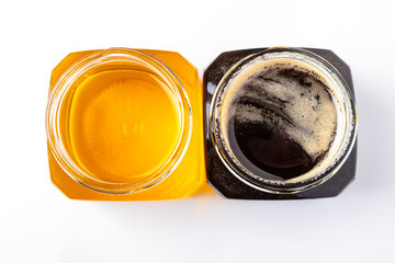 jars light and dark honey on a white background top view