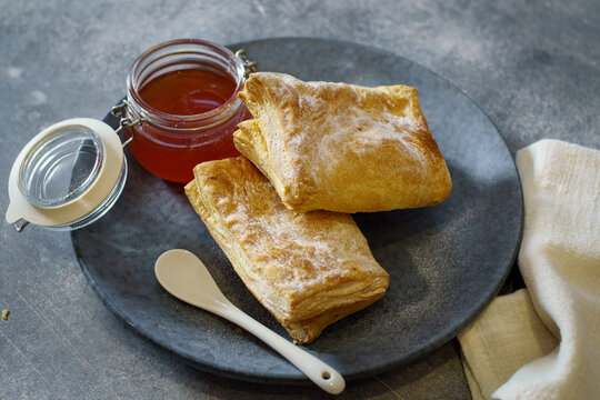 Puff pastry turnovers with jam on a plate. Low shallow focus