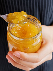 Red strawberry and peach yellow jam on plank wood and slice bread.