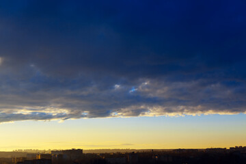 Dark clouds over the city . Dramatic sky in the evening