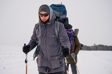 Fototapeta na wymiar Portrait of a guy in polarized glasses during a winter hike