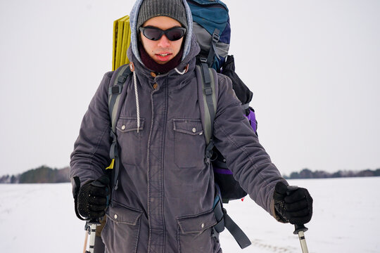 Portrait Of A Guy In Polarized Glasses During A Winter Hike