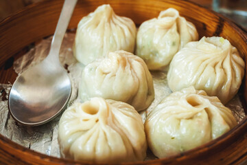 steamed dumplings in wooden basket 