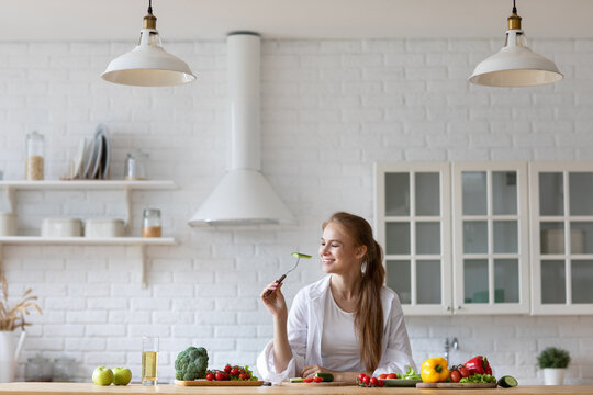 Young Woman Is Cooking In The Kitchen. Healthy Food - Vegetable Salad.