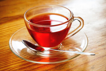 cup of tea with spoon on wooden table