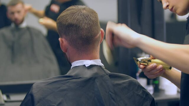 Haircut of a young guy in a hairdresser