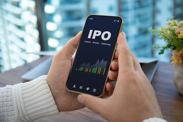 male hands hold phone with IPO stocks purchase app