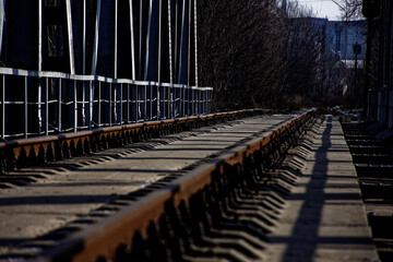 an abandoned railway bridge over a frozen river