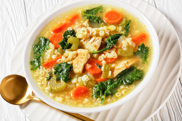chicken kale veggies soup in a bowl