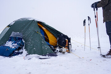 A tent with belongings stands in the snow © Serhii Prystupa