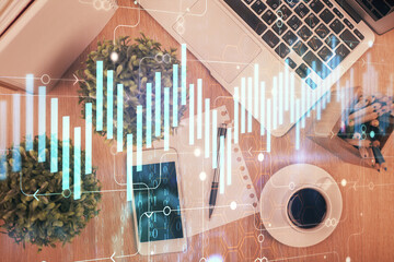 Multi exposure of financial chart hologram over desktop with phone. Top view. Mobile trade platform concept.