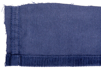 Lining of blue cotton corduroy retail, showing hem, against white background