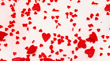 red hearts of different shapes on white concrete, stone texture