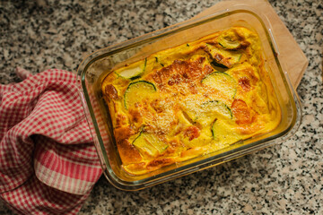 Fritatta with vegetables in glass baking tray.