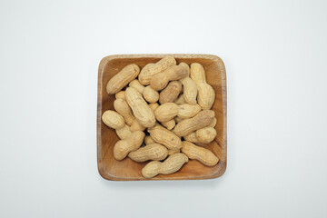pile of dried peanuts on a white background
