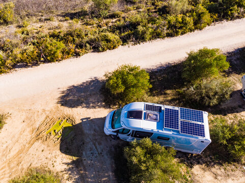Caravans with solar panels on roof camping on nature.