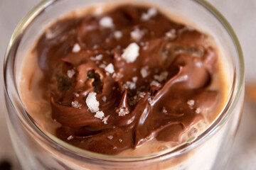 Salted dark chocolate iced coffee on white table on background. Top view.