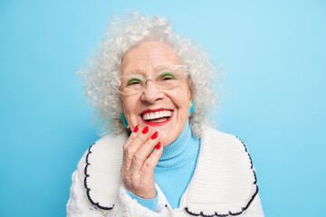 People old age positive emotions concept. Happy grey haired lady smiles broady has white even teeth...