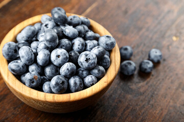 Fresh blueberries in a wooden bowl