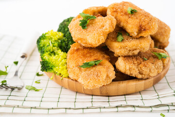 Chicken nuggets with vegetables, broccoli and ketchup on a white background