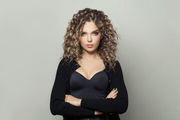 Healthy young woman with curly hairstyle on white background