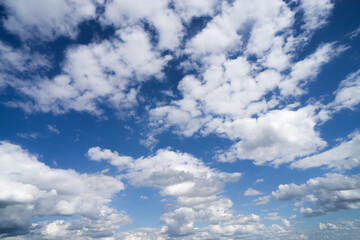 Bright cumulus clouds against a blue sky.