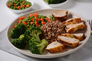 Healthy breakfast. Tasty buckwheat porridge, grilled chicken fillet and vegetables  boiled