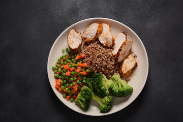 Healthy breakfast. Tasty buckwheat porridge, grilled chicken fillet and vegetables  boiled