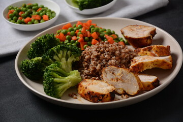 Healthy breakfast. Tasty buckwheat porridge, grilled chicken fillet and vegetables  boiled