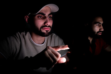 portrait of middle eastern guys setting together in a dark room