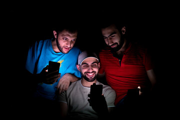 portrait of middle eastern guys setting together in a dark room