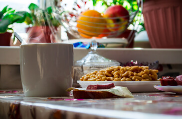 Morning breakfast in the village, hot tea, steam over a mug of tea.