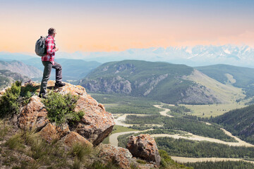 Hiker with backpack enjoying valley view at sunset.  Active healthy lifestyle adventure journey vacations.