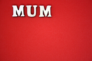 Fototapeta na wymiar MUM text on a red background. The concept of the holiday.