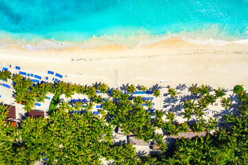 Paradise tropical island nature background. Top aerial drone view of beautiful beach with turquoise sea water and palm trees. Saona island, Dominican republic.