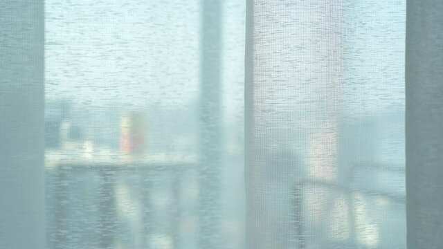 white sheer or translucent curtain and motion see through balcony and beverage cans for relax drink to soft light window and close in room on morning for home or hotel interior decor and background 4K