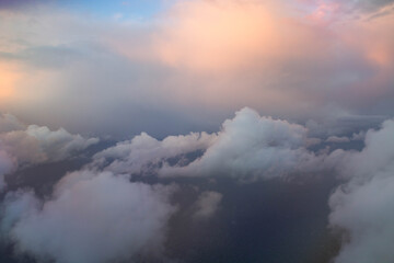spectacular sunset seen from an airplane with clouds in the foreground and in the distance
