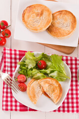 Puff pastry filled with tomato and mozzarella cheese.