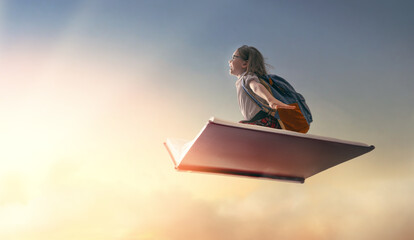 child flying on the book