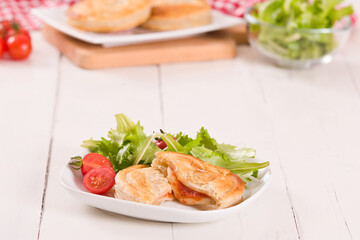 Puff pastry filled with tomato and mozzarella cheese.