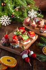 Festive Christmas meat mini snacks for the company on wooden boards