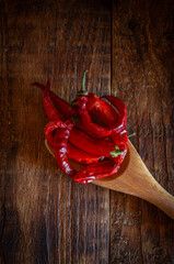 Red chili pepper on a wooden brown background